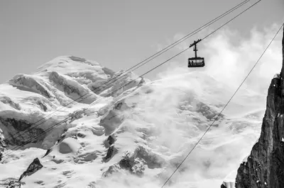 a person is skiing down a snow covered slope at Ancolie - Apartment Free parking close to ski lift - By Cozee Rentals in Chamonix-Mont-Blanc