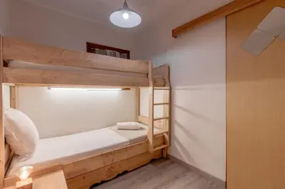 a bedroom with two bunk beds in a room at Jardin du Mont Blanc in Chamonix-Mont-Blanc