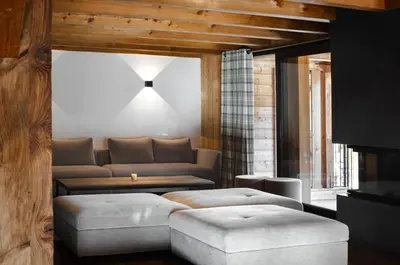 a living room with a couch and a table at MEGEVE Chalet d'architecte pour 16 personnes in Megève