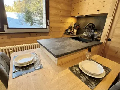 a kitchen with a sink and a table with plates on it at Studio confortable proche du centre avec parking, navette et randonnées à Megève - FR-1-597-190 in Megève