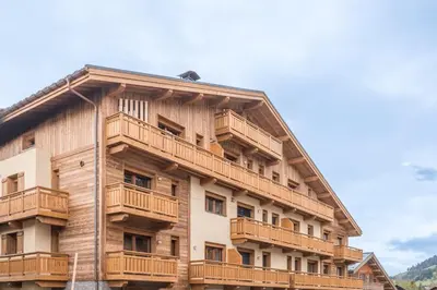 a large wooden building with balconies on it at Duplex des Rois - Welkeys in Megève