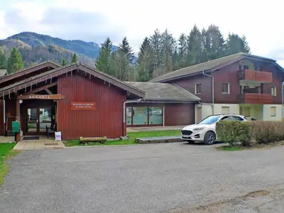 a car parked in a parking lot in front of a building at Appartement T2 6 pers avec Wifi et parking couvert - FR-1-629-145 in Samoëns