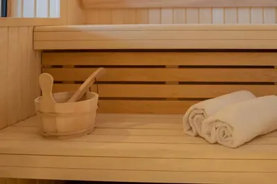 a sauna with towels and wooden utensils at Chalet Eteila vue incroyable ! Combloux 10 min de Megève in Combloux