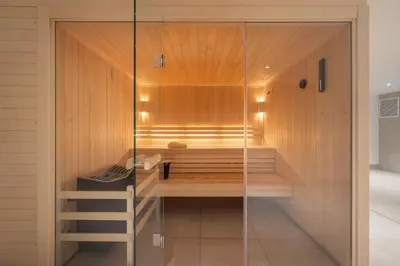a glass shower in a bathroom with a bench at Apartment Cumaru, Les Houches - by EMERALD STAY in Les Houches