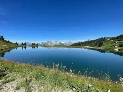 a view of a lake with mountains in the background at Samoëns 1600 au pied des pistes in Samoëns