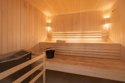 a sauna with a bench with a trash can in it at Apartment Mathilde Les Houches - by EMERALD STAY in Les Houches