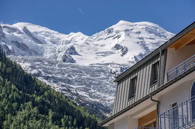 a view of a snow covered mountain from a building at Paradisa Terrasse Mont-Blanc Central 3-bedroom with Mont-Blanc View! in Chamonix-Mont-Blanc