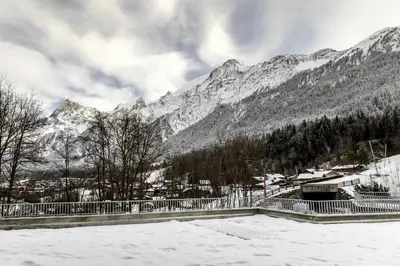 a snow covered mountain with a town in the background at Kayla du Mont-Blanc - Espace bien etre - Piscine in Les Houches