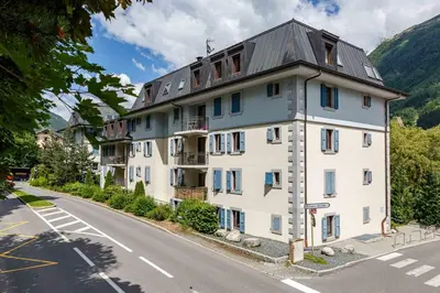 a large white building on the side of a road at Le Paradis ski apartment - Chamonix All Year in Chamonix-Mont-Blanc