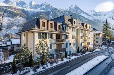 a house in the mountains with snow on the ground at Le Paradis ski apartment - Chamonix All Year in Chamonix-Mont-Blanc