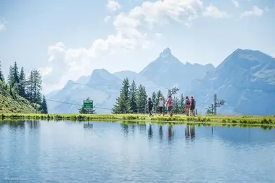 a group of people standing next to a body of water at BB222 - Appartement 6 pers pied de pistes in Les Carroz d'Araches