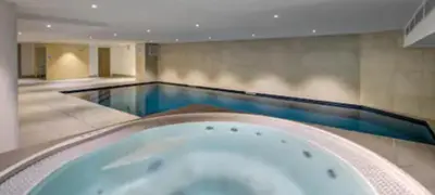 a large swimming pool with a bath tub at Les Ecrins de Kayla -Piscine - Sauna in Les Houches