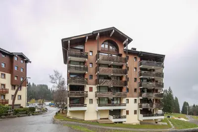 a building with balconies on the side of a street at Le Repos du Skieur - Au pied des pistes in Morillon