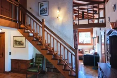 a living room with a staircase in a house at Stay in an ideal mountain chalet! in Megève