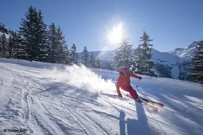 a person is skiing down a snow covered slope at PLA233 - Studio neuf 4 pers centre village in Les Carroz d'Araches