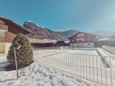 a house with snow on the ground in front of it at Appartement familial à Samoëns avec piscine et parking - FR-1-624-189 in Samoëns