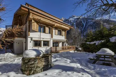 a house in the snow with a picnic table at Jacaranda 5 - Sublime 6pax - Central - Confort - Parking in Chamonix-Mont-Blanc