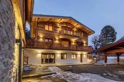 a large wooden house with a balcony on it at Ocma1 Somptueux 6pax Central Parking Confort in Chamonix-Mont-Blanc