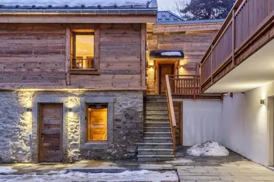a wooden house with stairs leading up to it at Ocma5 Somptueux 6pax Vue MtBlanc Central Parking in Chamonix-Mont-Blanc