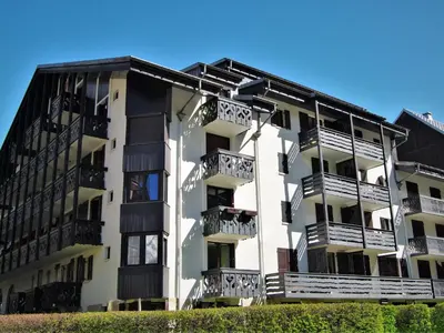 a group of people standing outside of a building in the snow at Apartment Le Triolet-8 by Interhome in Chamonix-Mont-Blanc