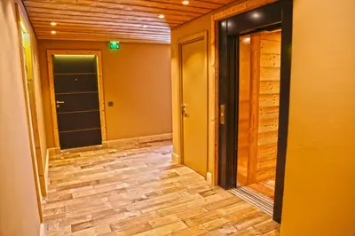 an empty hallway with wood floors and doors at Megève appart – 2 bedroms – AW301 in Megève