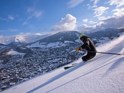 a man is skiing down a snow covered slope at Appartement 2 pièces au rez-de-chaussée - Animaux admis - Près des pistes - FR-1-453-91 in Megève