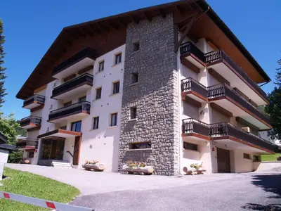 a building with balconies on the side of it at Appartement 2 pièces au cœur de Megève avec balcon et parking - FR-1-453-118 in Megève