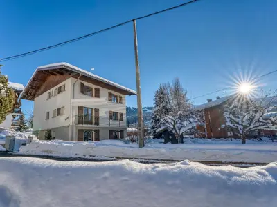 a building in the snow in front of a building at Appartement 2 pièces avec balcon et parking à Megève - FR-1-453-120 in Megève