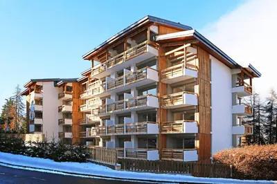 an apartment building with balconies on the side of it at Fantastic tenement Megève - AE 101 in Megève