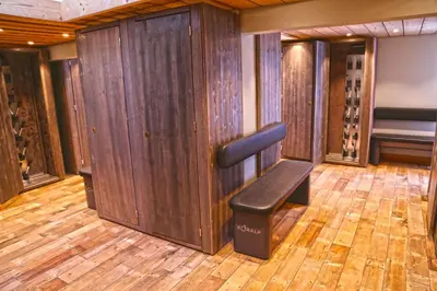 a bench in a wine cellar with wooden walls at Fantastic tenement Megève - AE 101 in Megève