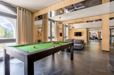 a living room with a pool table in it at La Cordee 504 Apartment - Chamonix All Year in Chamonix-Mont-Blanc
