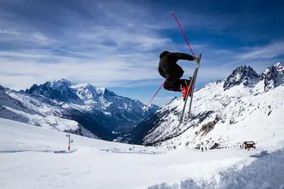 a person doing a trick on skis in the snow at La Cordee 504 Apartment - Chamonix All Year in Chamonix-Mont-Blanc