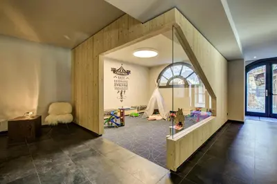 a childrens room with a play area with a window at Résidence Luxe 5*,Spa & Fitness, La Cordée Appartement 214 in Chamonix-Mont-Blanc