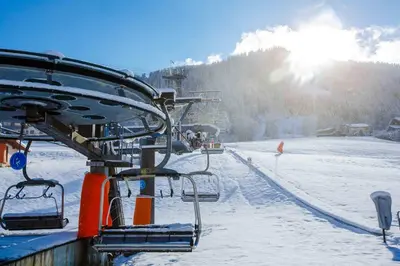 a ski lift with people on it in the snow at Fabulous Residence Lesporting Ski - AE203 in Megève