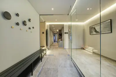 a hallway of a house with a glass wall at The Drus Luxury Apartment with Spa and Indoor Pool in Chamonix-Mont-Blanc
