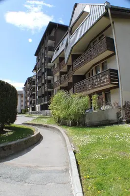 a building with a curvy sidewalk next to a building at Apartment Grepon 3A - A Central Chamonix Haven in Chamonix-Mont-Blanc