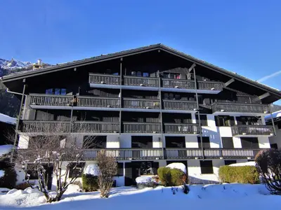 a large building with balconies in the snow at Apartment Champraz-15 by Interhome in Chamonix-Mont-Blanc