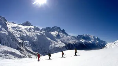 a group of people skiing down a snow covered mountain at Apartment Grepon 2 - A Chamonix Alpine Haven in Chamonix-Mont-Blanc