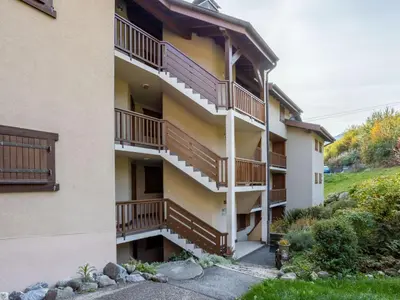 an apartment building with a lawn in front of it at Apartment Aiguille du midi by Interhome in Saint-Gervais-les-Bains