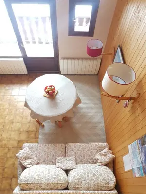 a living room with a couch and a table at CHALET DES NEIGES in Les Carroz d'Araches