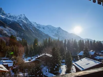 a town with a snowy mountain in the background at Studio Charmant avec Vue Mont Blanc, Parking et Animaux Admis - FR-1-517-35 in Chamonix-Mont-Blanc