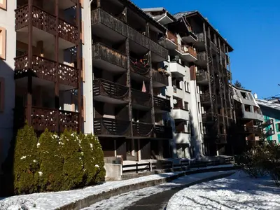 an apartment building with snow on the ground at Studio Chamonix 20m², 4 pers, balcon, parking - FR-1-517-40 in Chamonix-Mont-Blanc