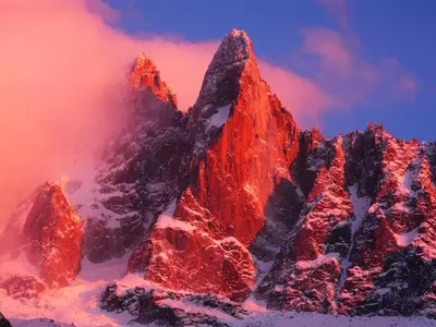 a mountain covered in snow with a red sky at Apartment Arve - Chamonix Peaks Retreat in Chamonix-Mont-Blanc