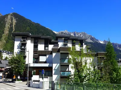 a white building with a mountain in the background at Studio L'Aiguille du Midi-8 by Interhome in Chamonix-Mont-Blanc