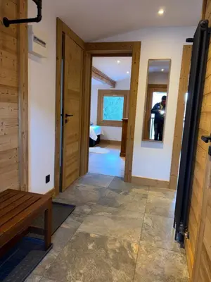 a hallway with a door and a bench and mirrors at The Castle, 10 Bedroom Chalet, Chamonix Centre in Chamonix-Mont-Blanc