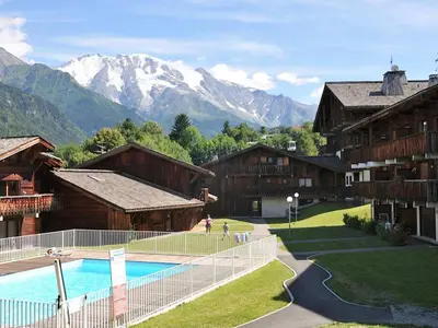 a large wooden building with snow in front of it at Studio Les G'rets-10 by Interhome in Saint-Gervais-les-Bains