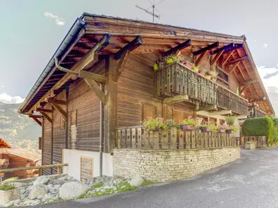a wooden house with a balcony and flowers on it at Studio Les G'rets-10 by Interhome in Saint-Gervais-les-Bains
