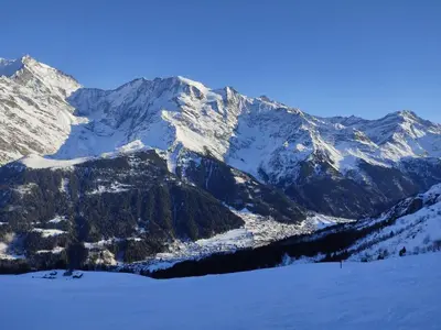 a snow covered mountain range with a ski slope at Apartment A la Claire Fontaine 2 by Interhome in Mémontel