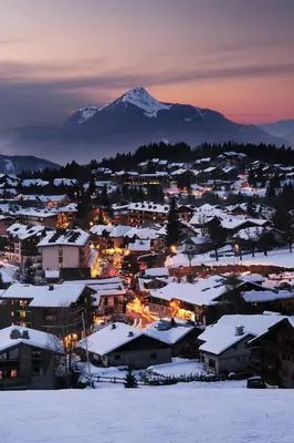 a town covered in snow with a mountain in the background at Studio 4 Pers (AM113) in Les Carroz d'Araches