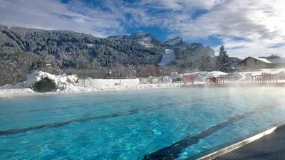 a pool of water with snow and mountains in the background at BA112 Studio 4 Pers Pied de pistes Carroz in Les Carroz d'Araches
